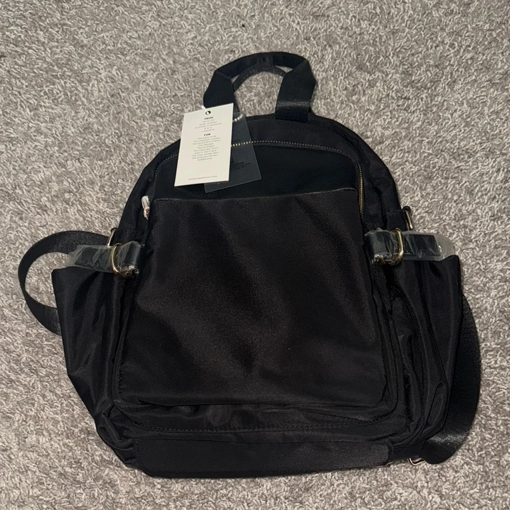 Sleek Black Backpack with Gold Zippers